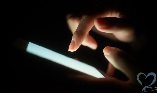 暗がりで光るスマホ